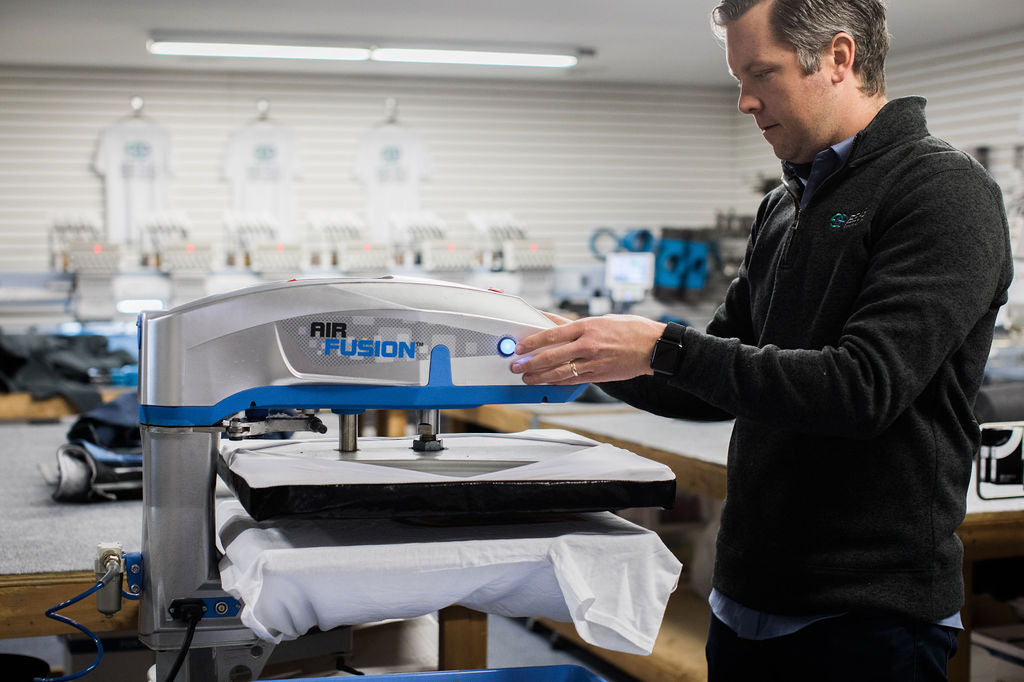 Printer, printing tshirt on press. Linked to decoration methods page.