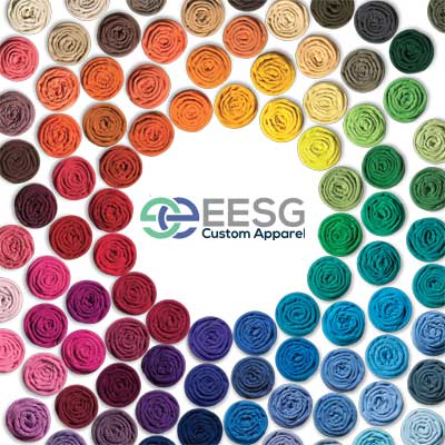 Different color tshirts rolled up and aligned in circles with the EESG Custom Apparel logo at the center.