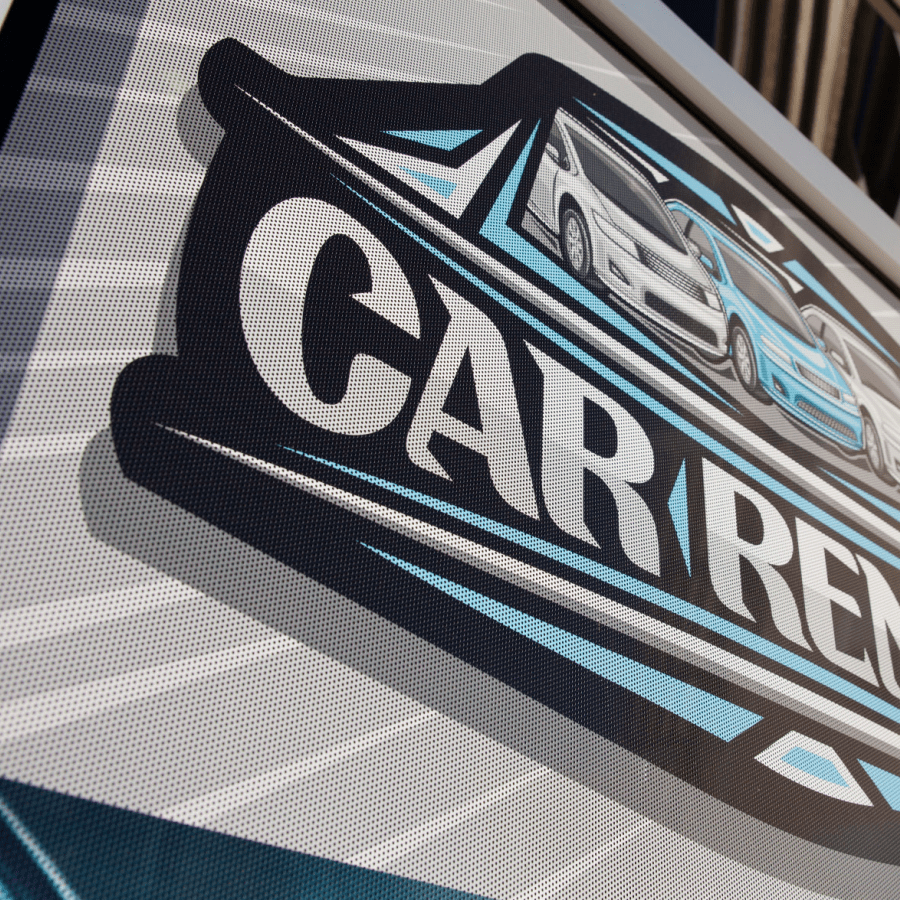 perforated vynal sign sample with a car rental logo, linked to sign page.